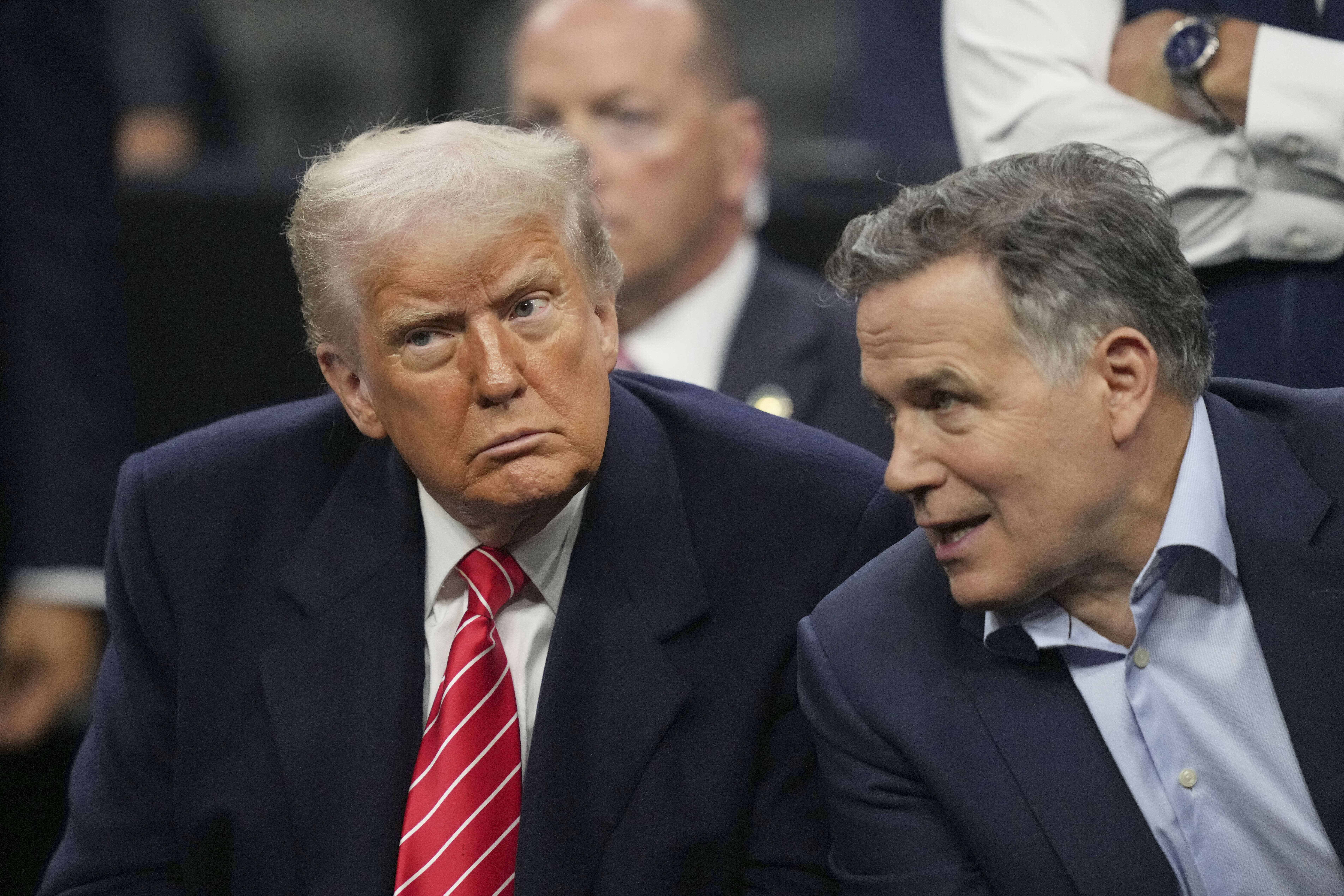 President Donald Trump, left, and Sen. Dave McCormick, R-Pa., attend the finals at the NCAA wrestling championship, Saturday, March 22, 2025, in Philadelphia. 