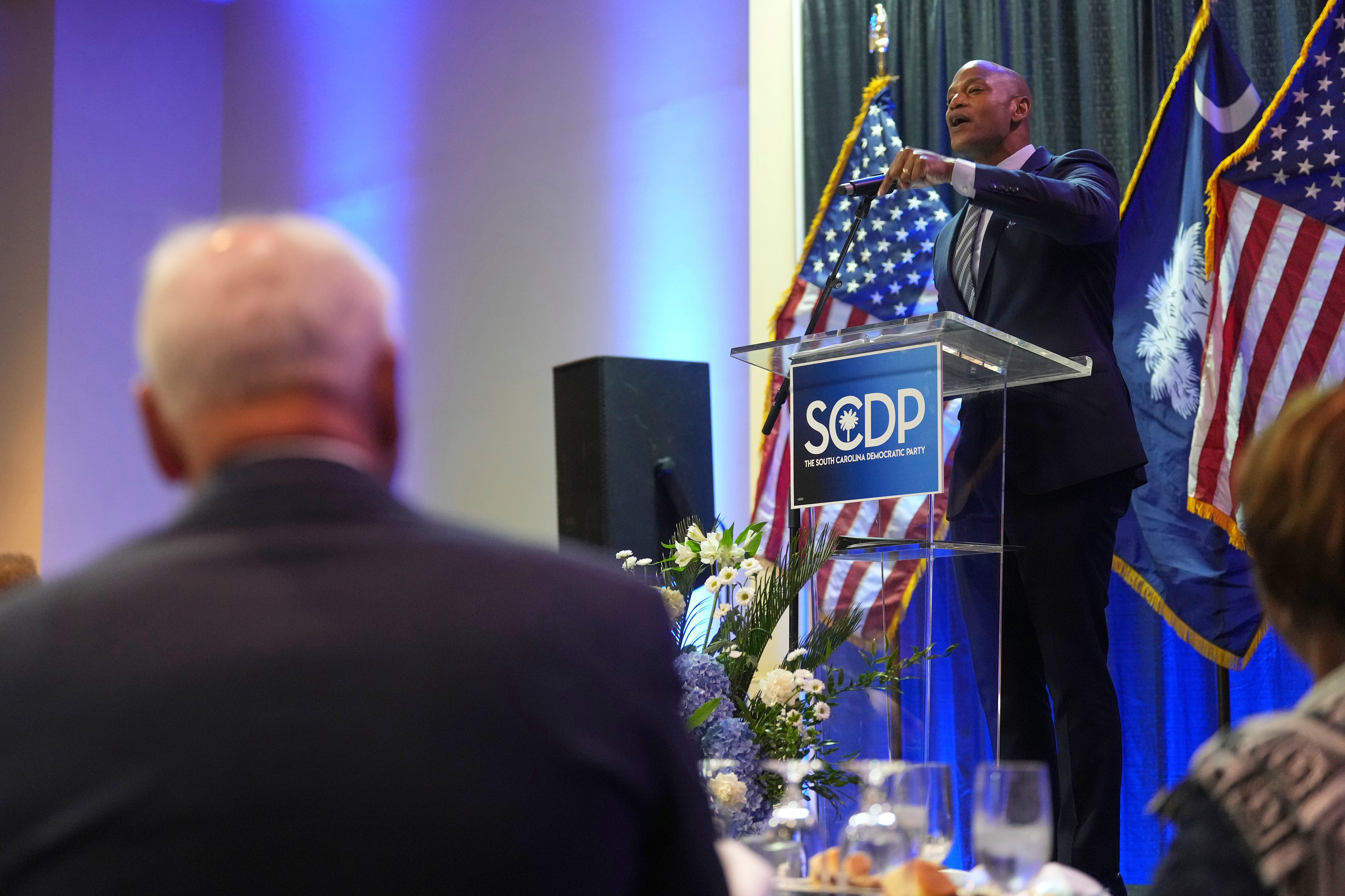 Maryland Gov. Wes Moore, right, speaks at the South Carolina Democratic Party's Blue Palmetto Dinner as Minnesota Gov. Tim Walz, left, listens, May 30, 2025, in Columbia, South Carolina.