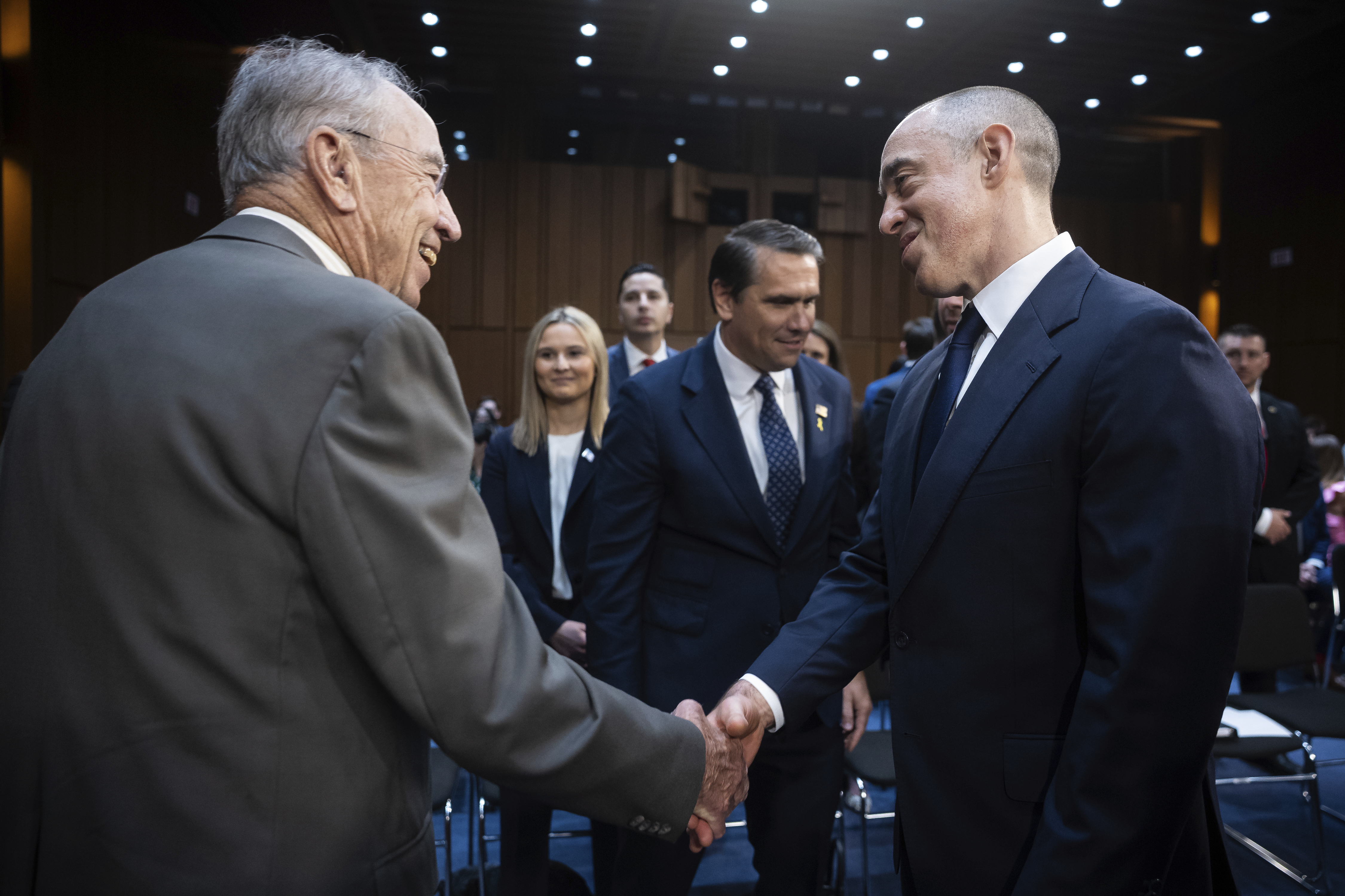 Senate Judiciary Committee Chair Chuck Grassley (R-Iowa) greets Emil Bove, nominee to be U.S. circuit judge for the third circuit, before a hearing on Capitol Hill June 25, 2025. Deputy Attorney General Todd Blanche is seen, left of Bove.