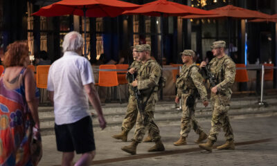 National Guard troops begin carrying firearms in Washington