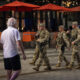 National Guard troops begin carrying firearms in Washington