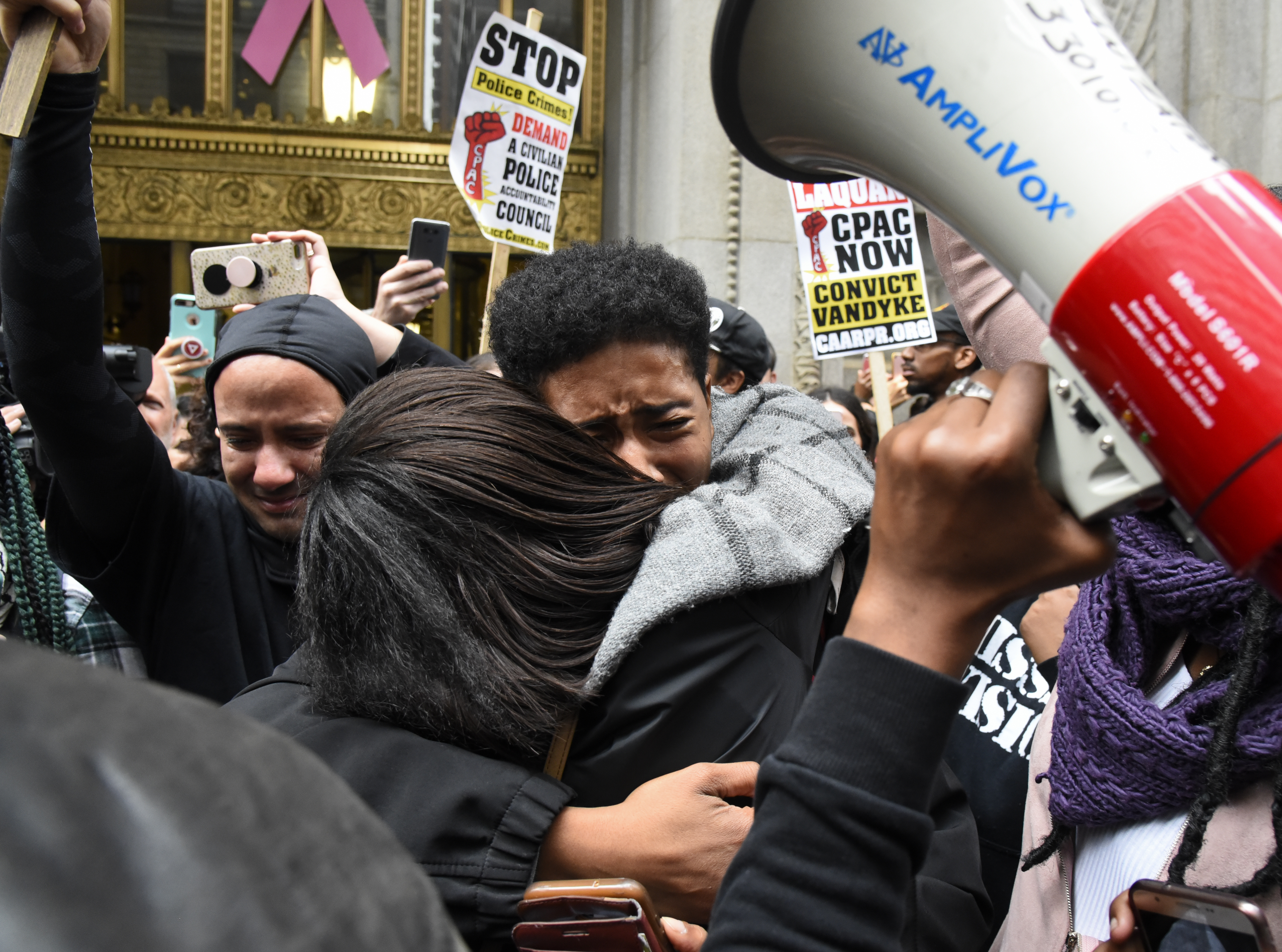 People react outside the city hall in Chicago on Friday, Oct 5, 2018, after a jury convicted Chicago Police Officer Jason Van Dyke of second-degree murder in the 2014 shooting of Laquan McDonald. The white Chicago officer was convicted of second-degree murder Friday in the shooting of the black teenager that was captured on shocking dashcam video that showed him crumpling to the ground in a hail of 16 bullets as he walked away from police. (AP Photo/Matt Marton)