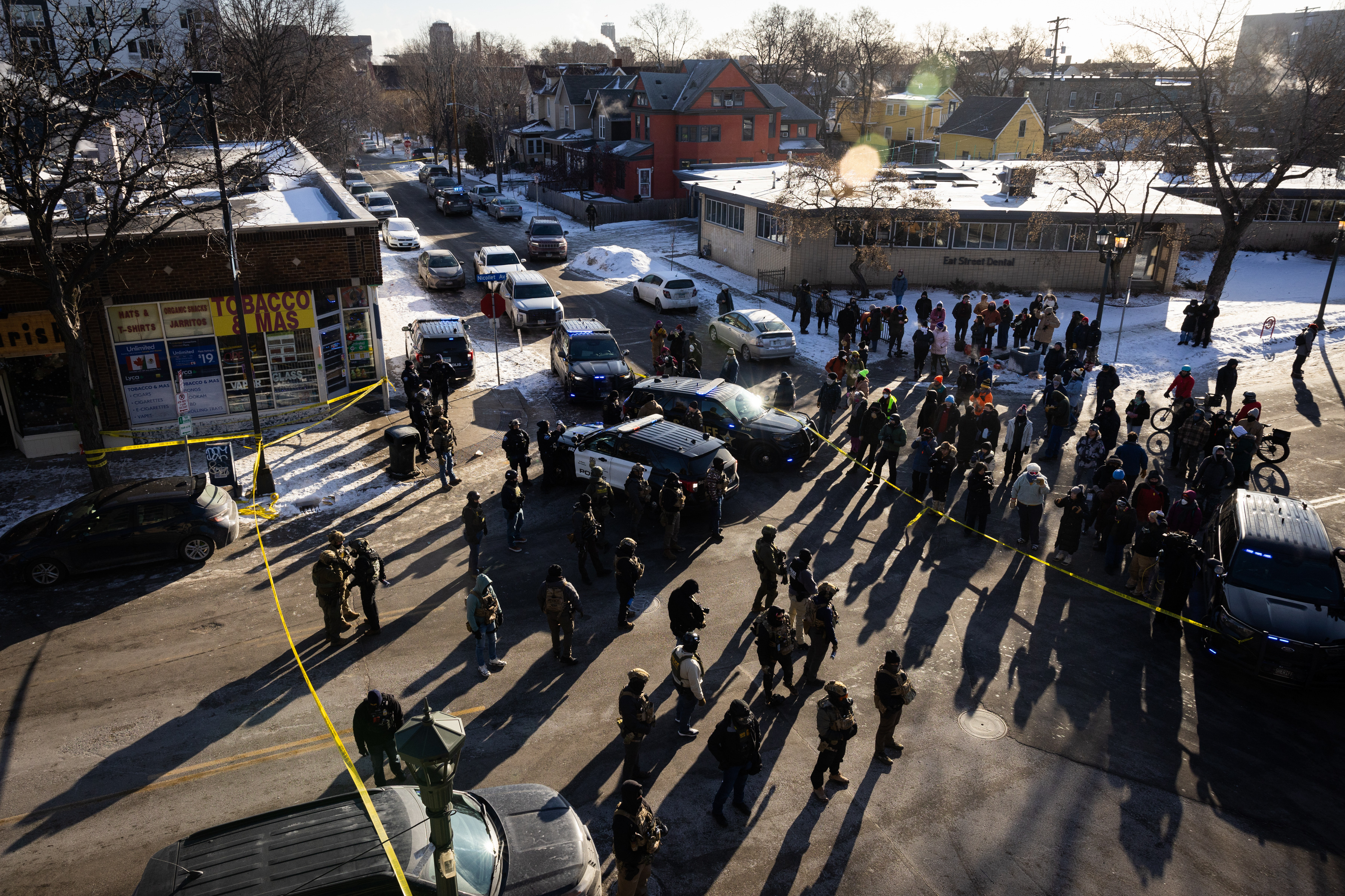 People gather at the intersection of 27th Street and Nicollet Avenue in Minneapolis after a federal officer shot and killed 37-year-old Alex Pretti on Jan. 24, 2026.