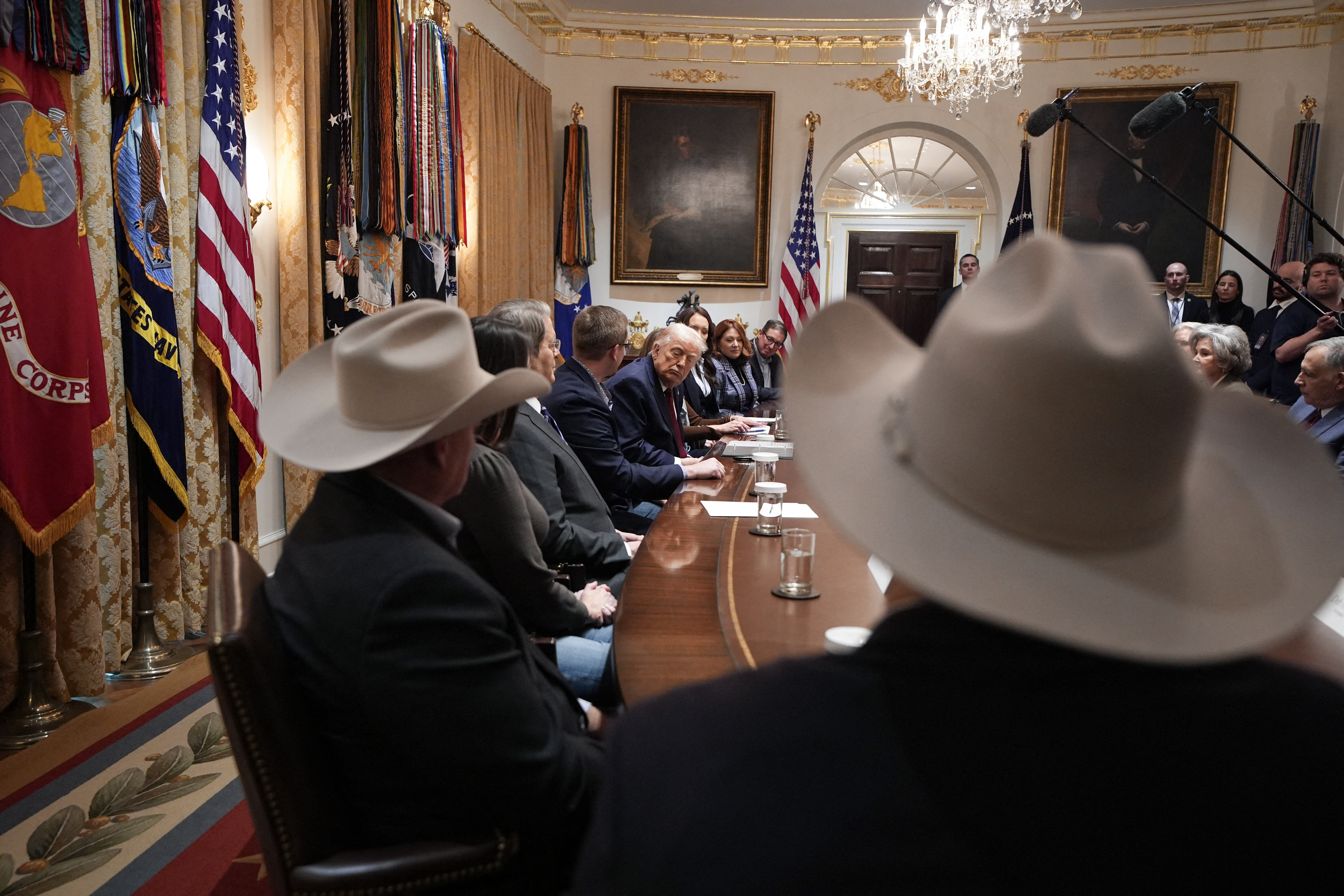 Trump listens during a roundtable discussion where he announced a $12 billion aid plan for farmers on Dec. 8, 2025.