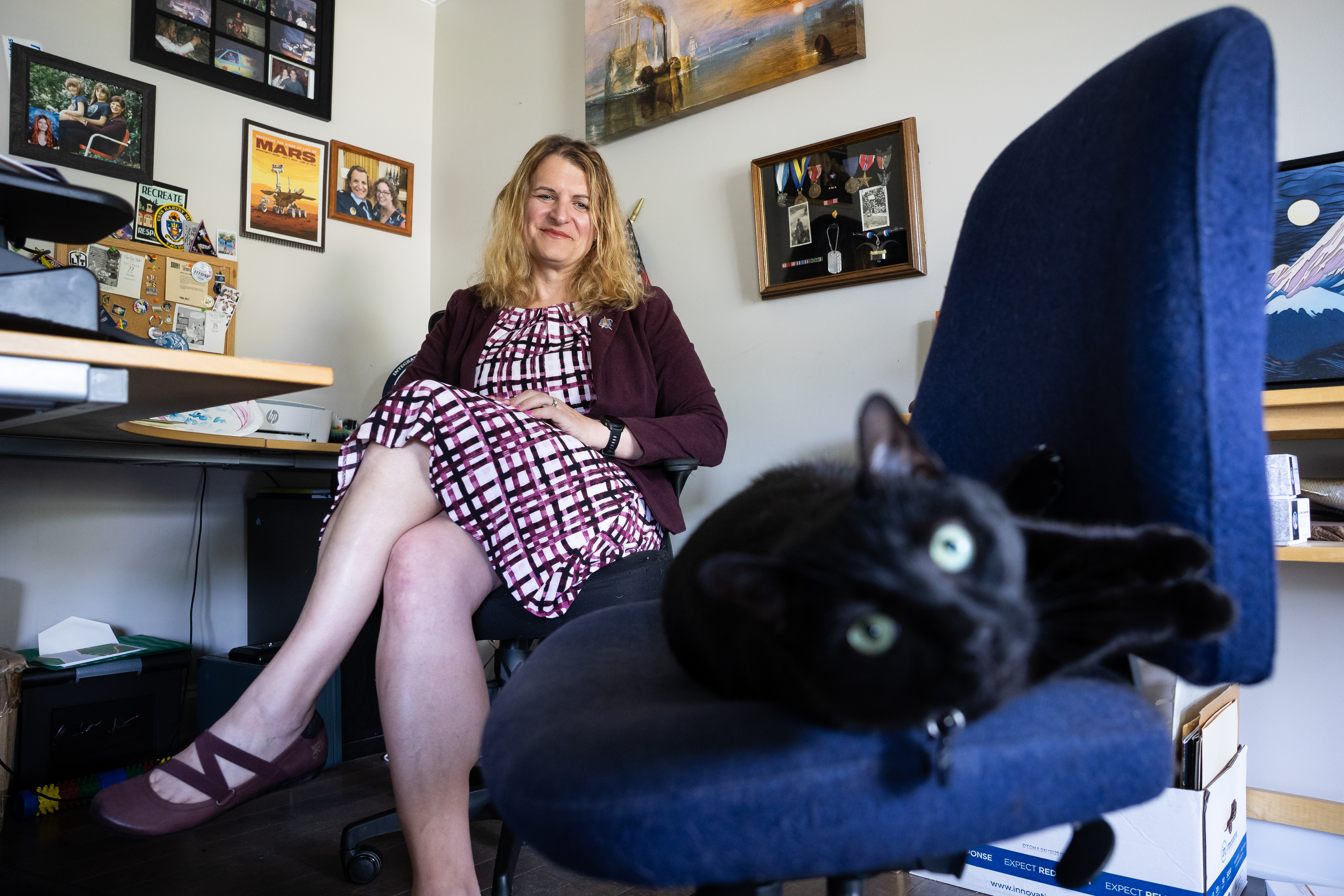 Fram sits with her cat, Worf, in her home in Reston.