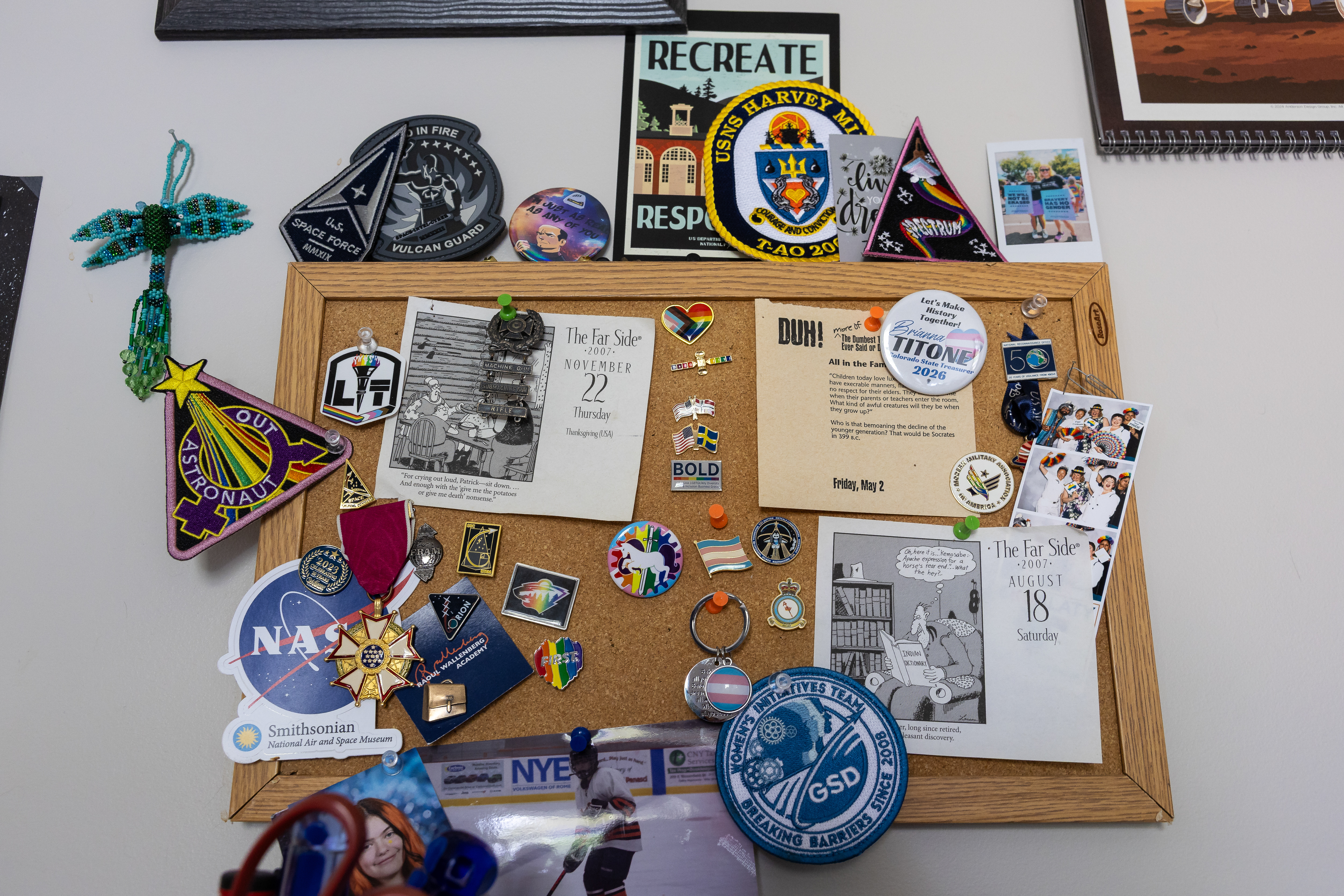 A bulletin board with military memorabilia and other items is seen in Fram's home.