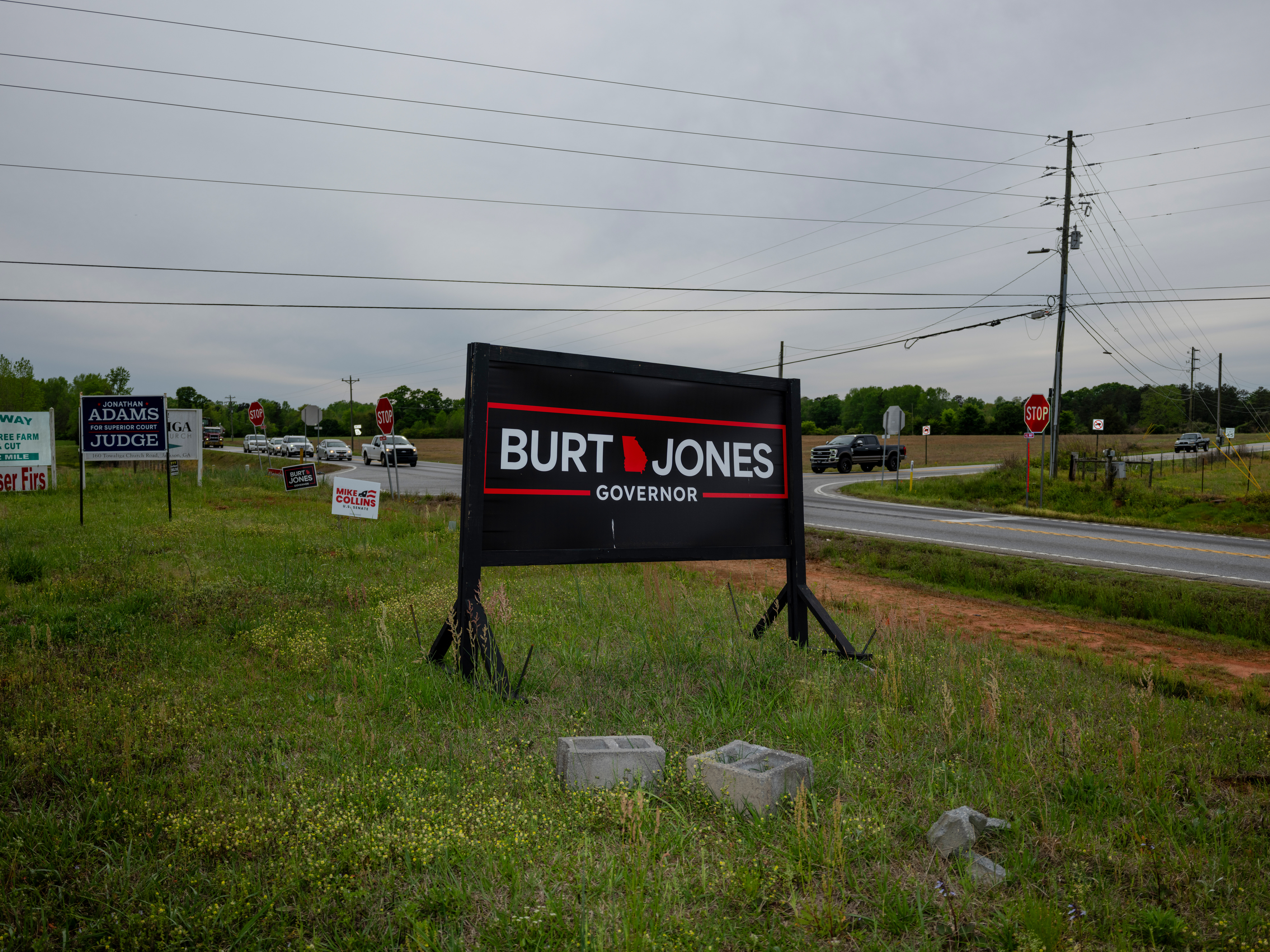 A sign for Jones towers over others on a roadside in Butts County, Georgia, on April 6.