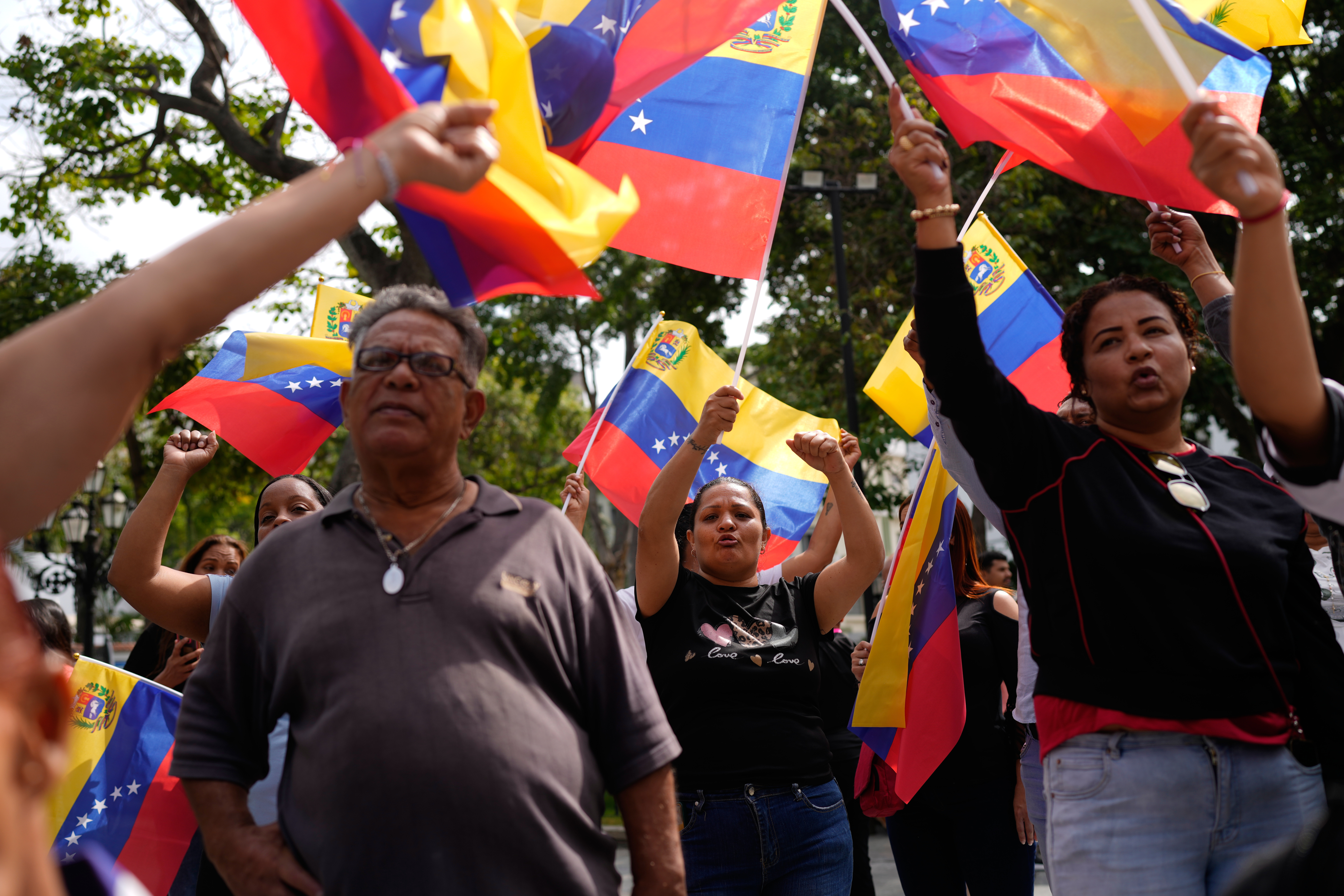 People gather at a government-organized event to watch former President Nicolas Maduro and first lady Cilia Flores appear in a New York court on a screen in Caracas, Venezuela, on March 26, 2026.