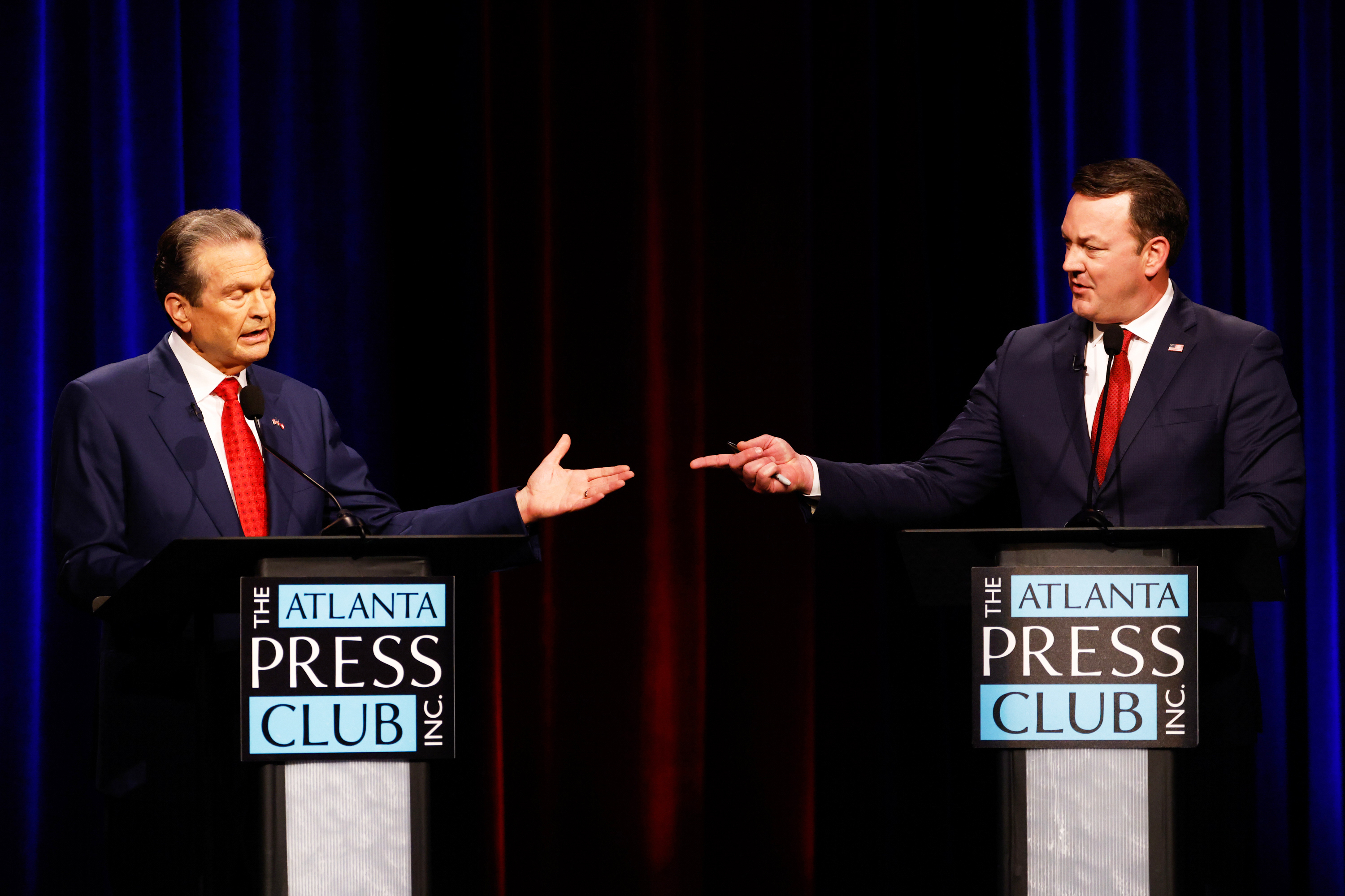 Gubernatorial candidates Rick Jackson, left, and Burt Jones interact at the Atlanta Press Club Loudermilk-Young Republican primary election debate in Atlanta, on April 27, 2026.