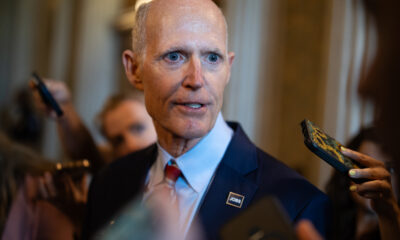 Rick Scott says he’s just trying to help