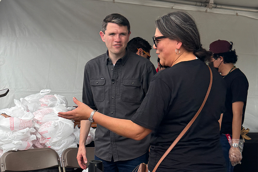 James Talarico talks to a volunteer at the McAllen pit stop of his bus tour.