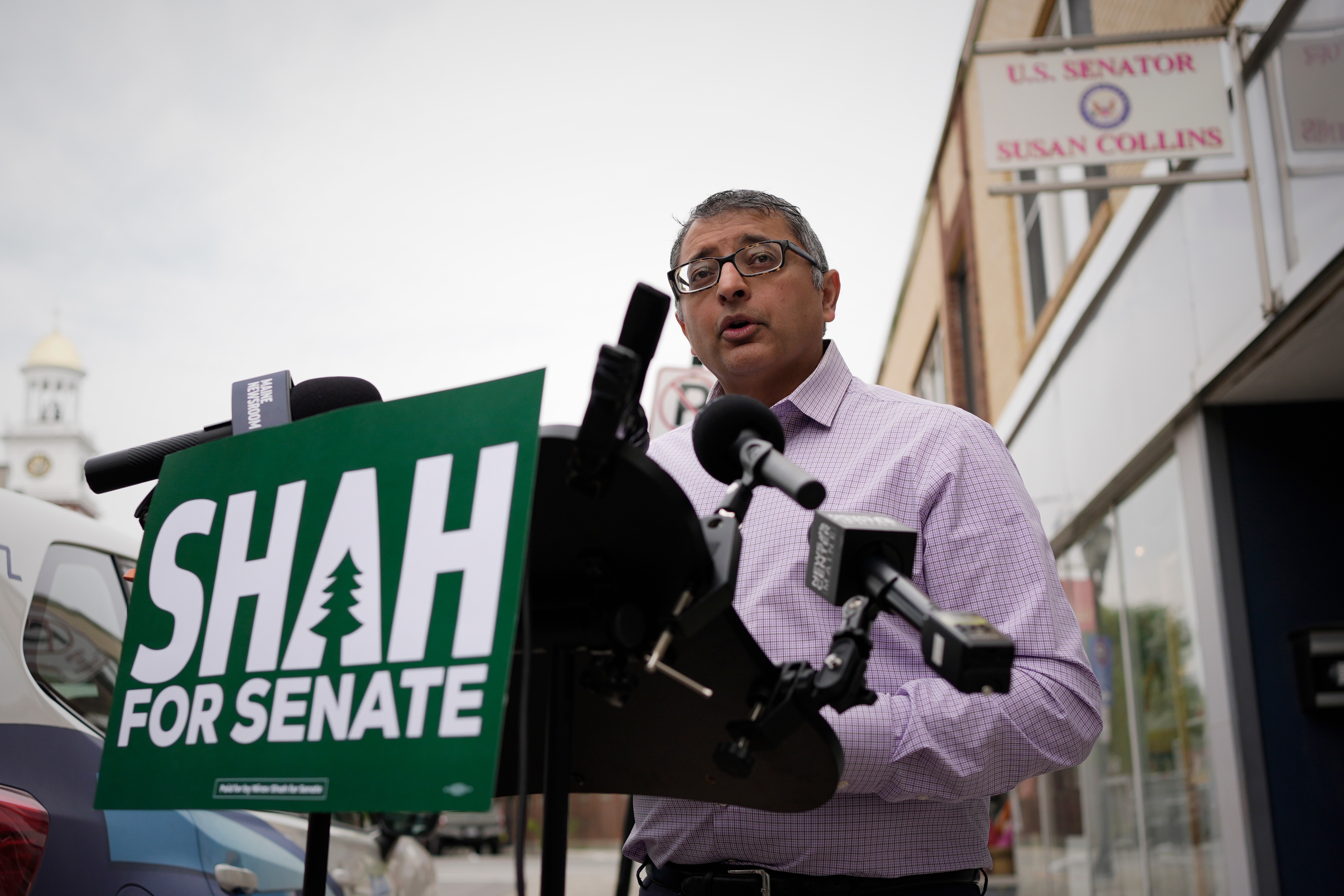 Dr. Nirav Shah, Democratic candidate for U.S. Senate, speaks to reporters outside an office for GOP Sen. Susan Collins on July 14, 2026, in Biddeford, Maine.