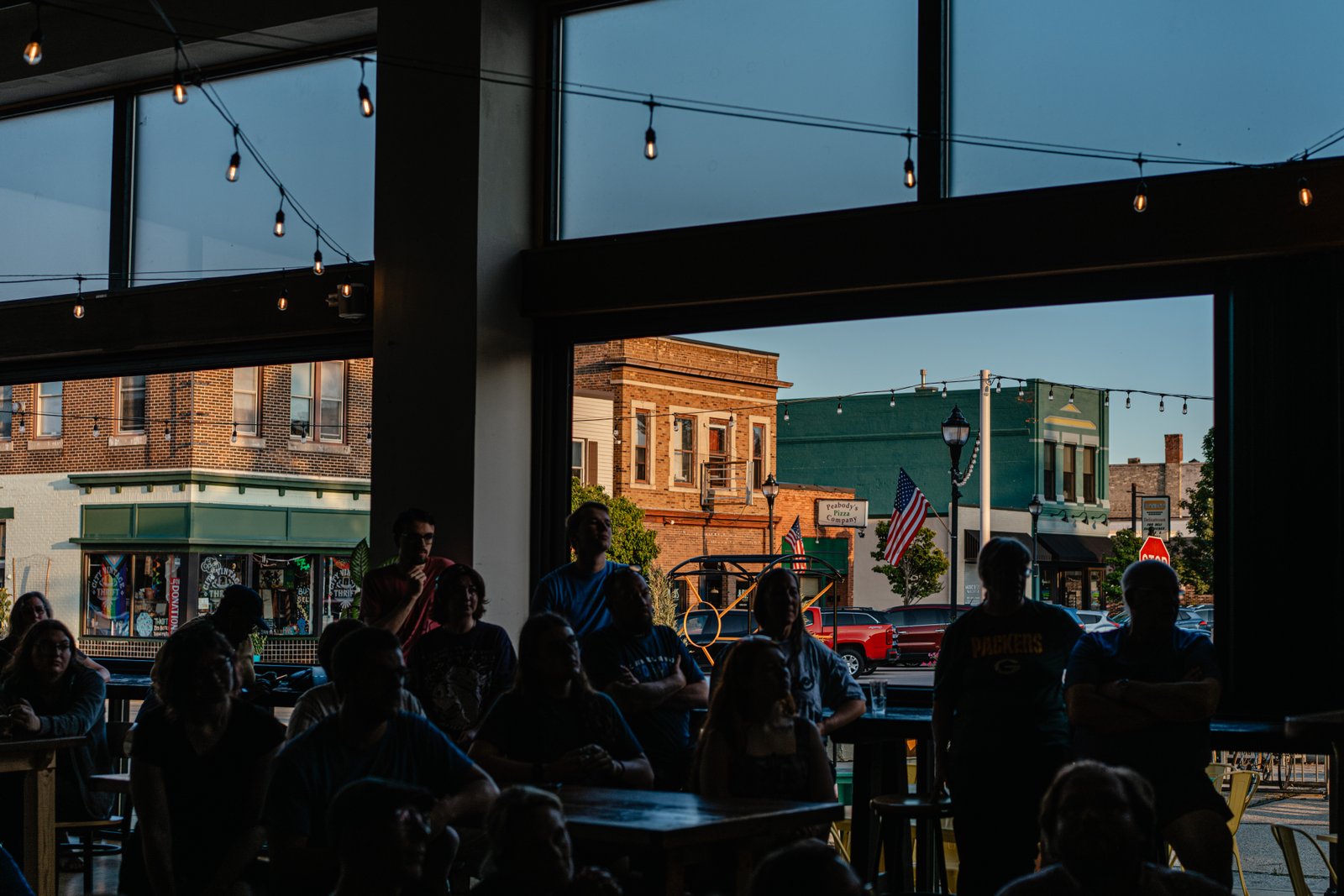 People listen to Hong speak at Paradigm Coffee and Music in Sheboygan on Aug. 8.