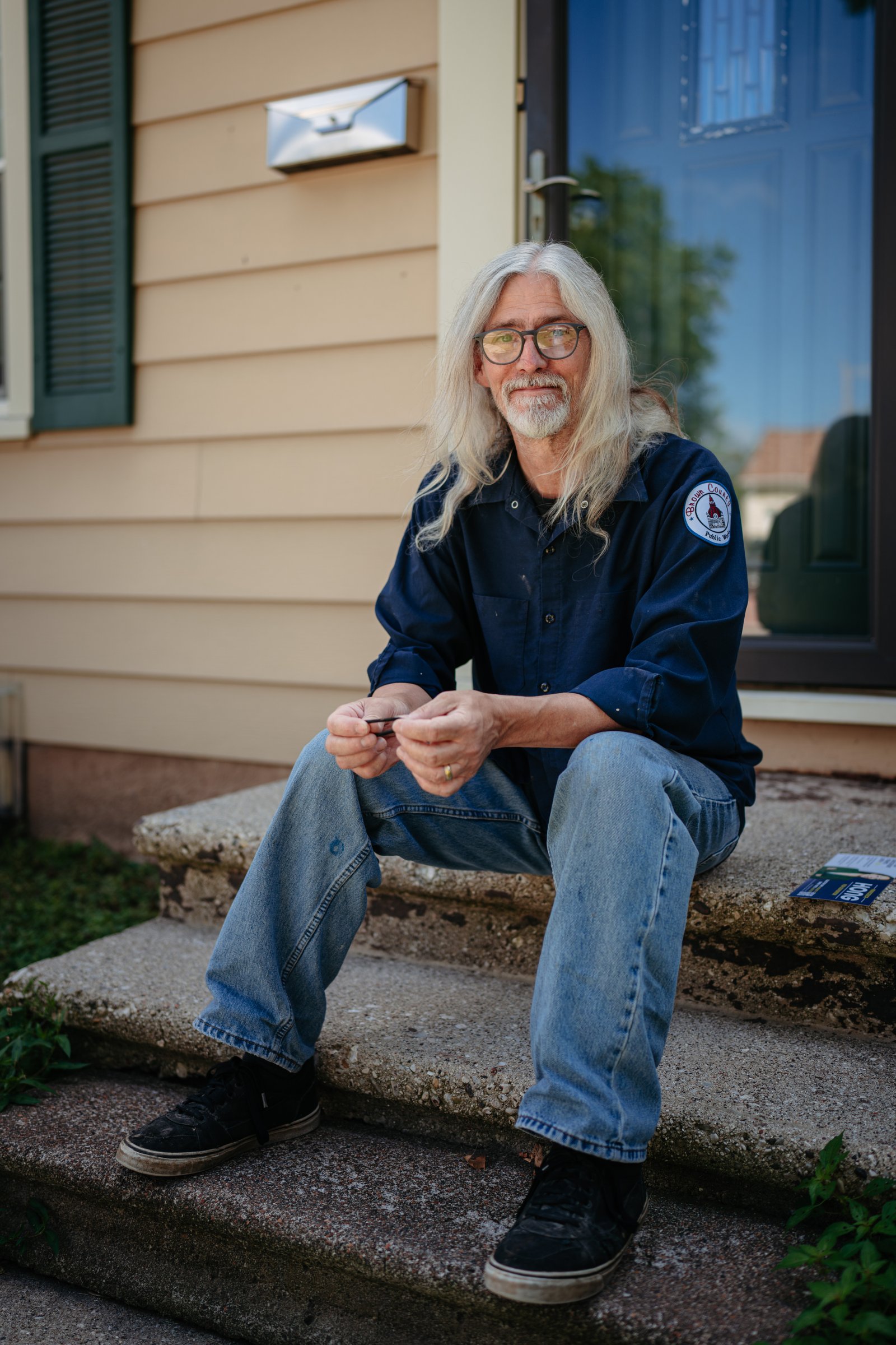 Tim Freiss sits in front of his home in Green Bay.
