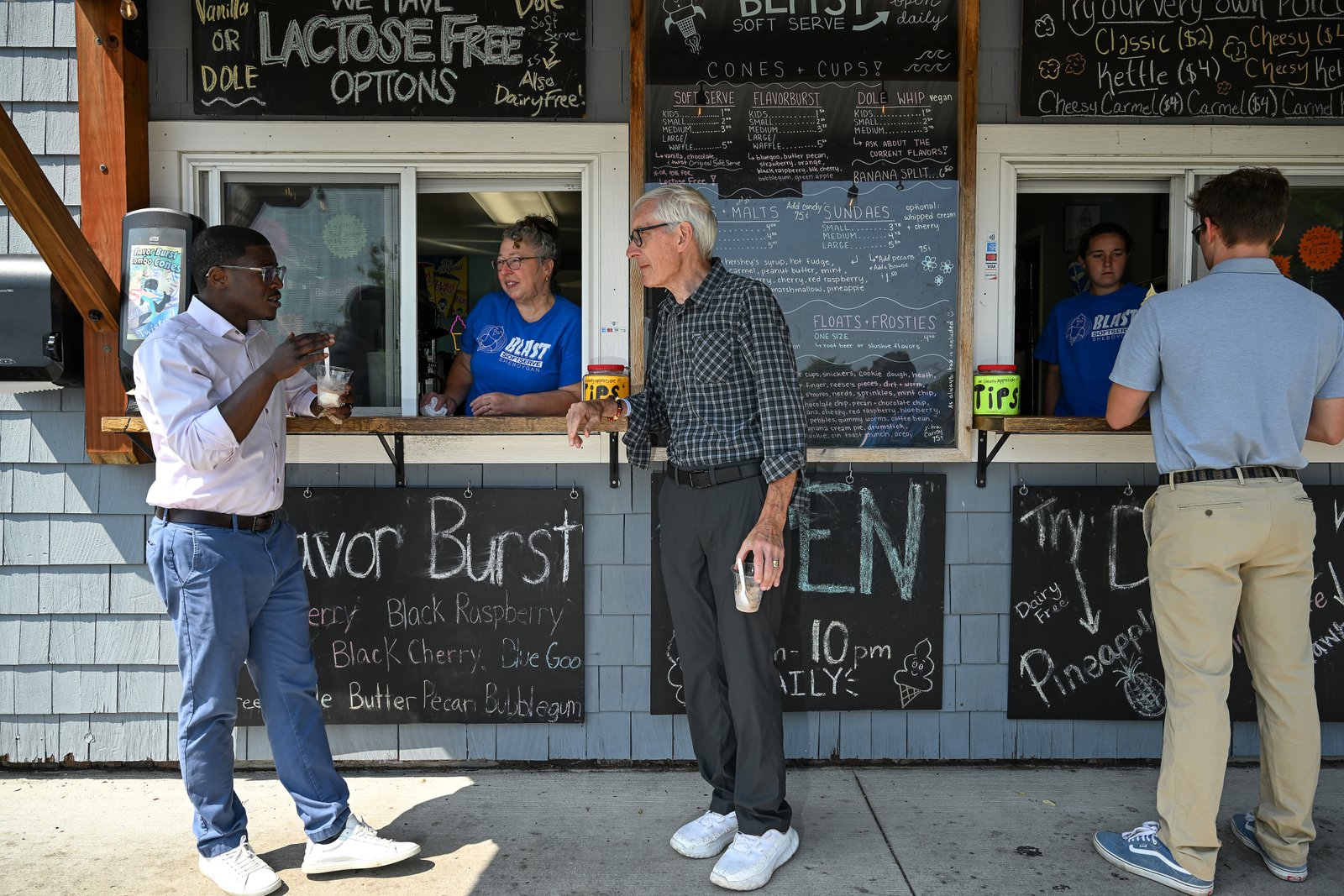 Crowley, left, speaks with Blast Soft Serve ice cream shop owner Jamie Evans, center, and Wisconsin Gov. Tony Evers during a campaign stop in Sheboygan.