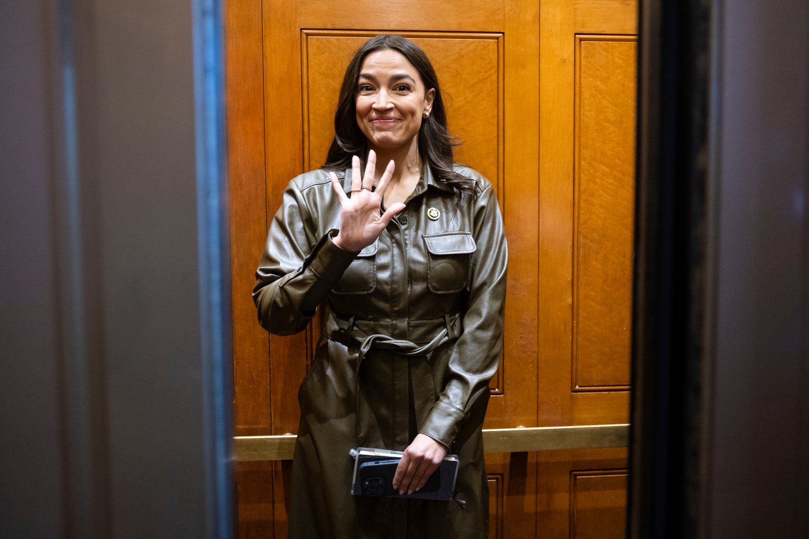 Rep. Alexandria Ocasio-Cortez (D-N.Y.) waves as she boards an elevator on the Senate side of the U.S. Capitol March 21, 2024. 