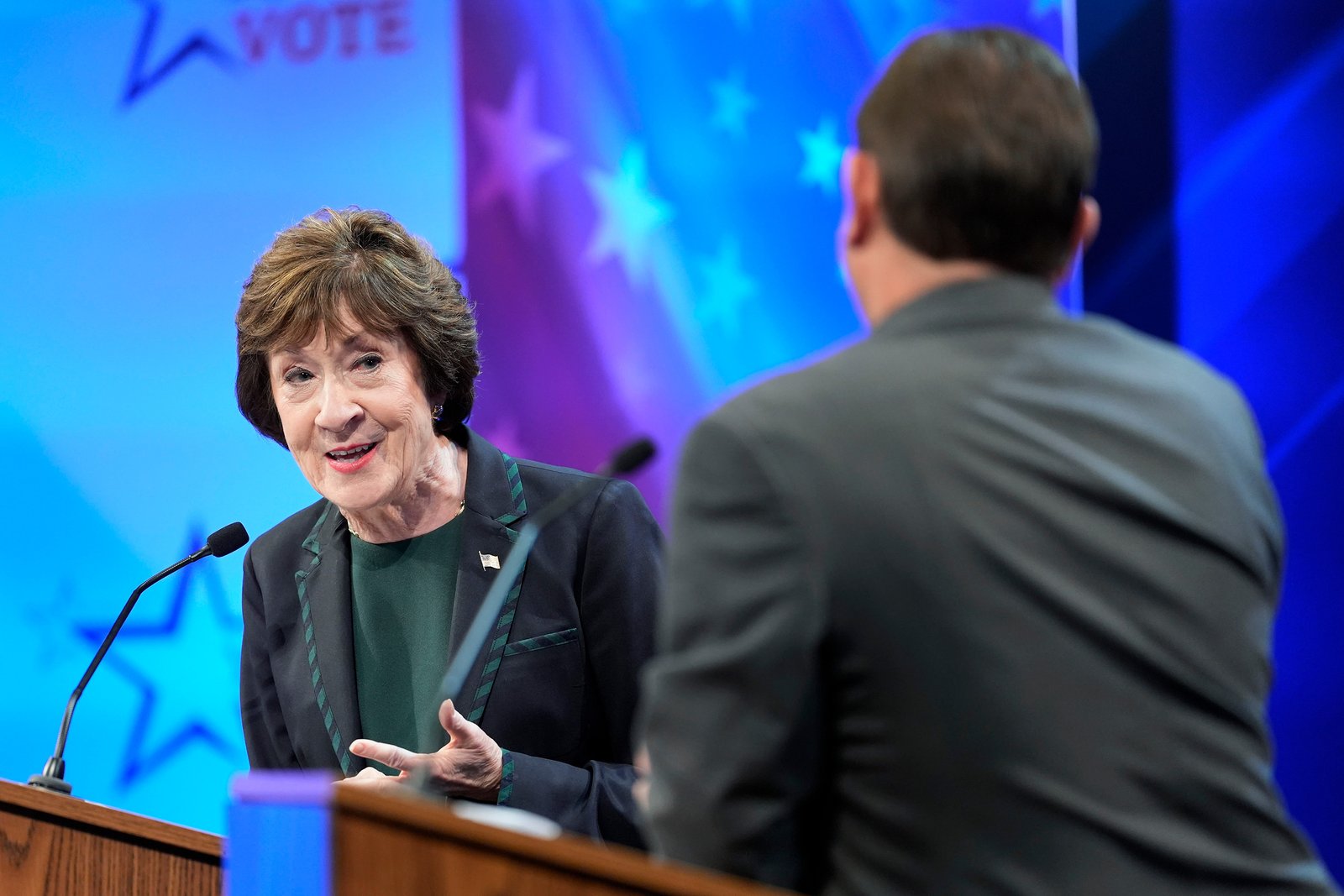 Sen. Susan Collins looks to Troy Jackson as he answers a question during the final Maine U.S. Senate debate in Bangor, Maine, on Oct. 15, 2026.