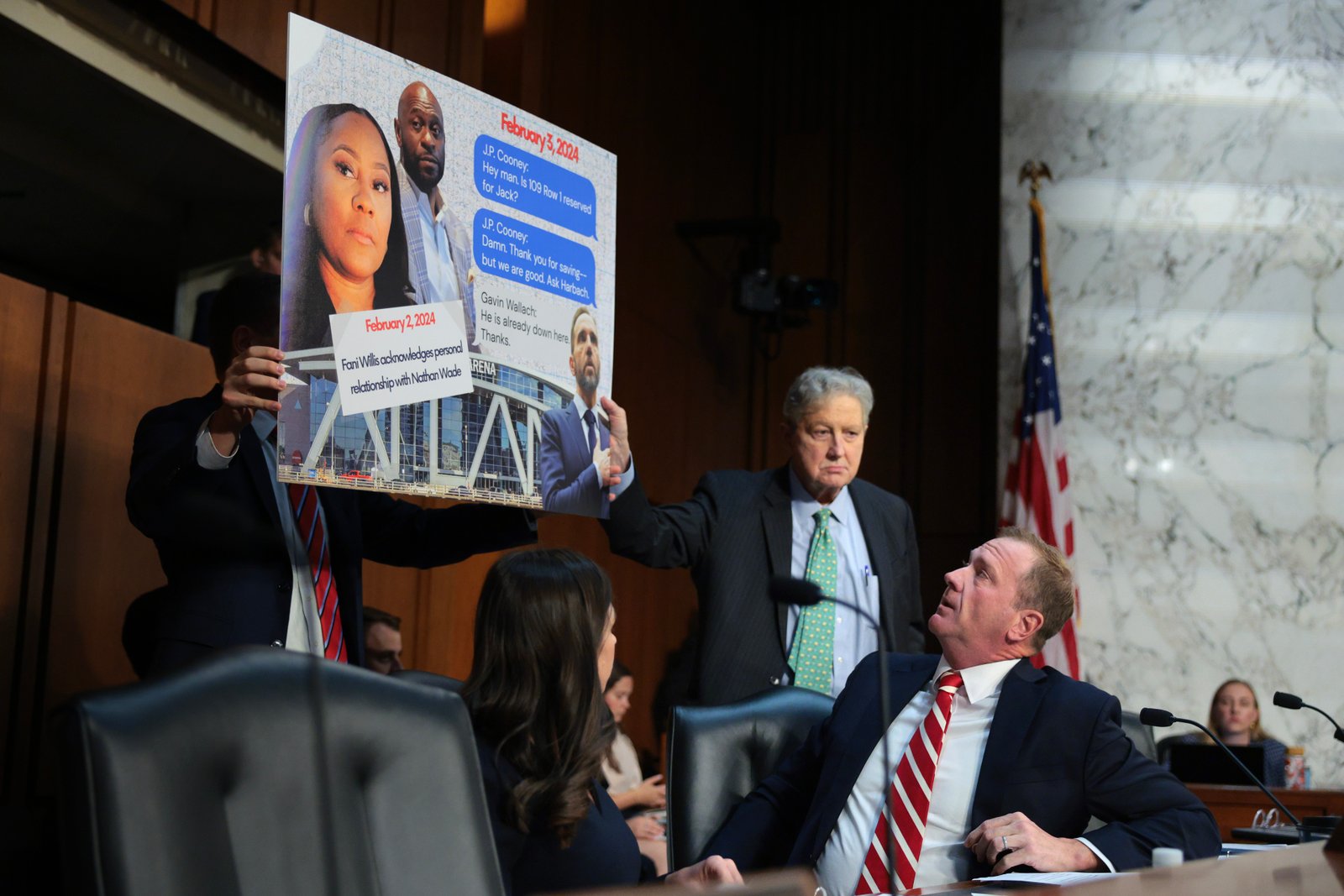 Sen. Eric Schmitt (R-Mo.) and Sen. John Kennedy (R-La.) display a sign accusing Jack Smith of meeting with Fani Willis during a Senate Judiciary Committee hearing in Washington, D.C., on Sept. 29, 2026.
